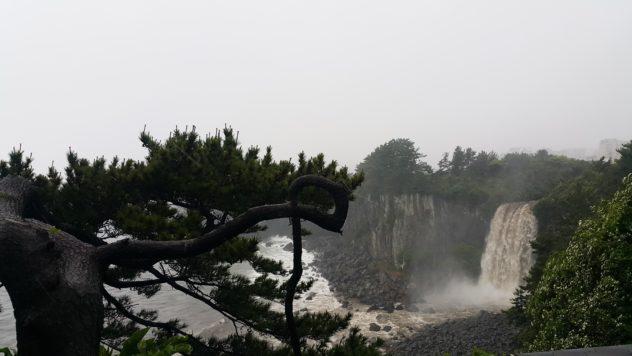 Jeongbang Waterfall, unfortunately sans rainbow, here. | #travel #korea #jeju #island #itinerary